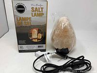 Box packaging showing product branding in English and French and image of salt lamp.