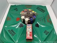 Full view of green poker Rummoli board with Hoyle poker chip tray holding colored chips and sealed Hoyle poker chip box.