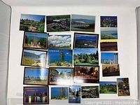 Overall view of 21 vintage postcards laid out showing Vancouver sights and popular locations