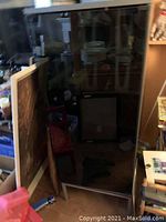 Front view showing glass door and shelves inside the Ikea stereo stand