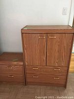 Full view of the highboy cabinet and matching nightstand showing their size, proportions, and finish.