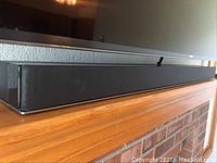 Side view of black Sony sound bar under TV