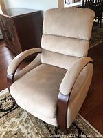 Front view of beige microfiber recliner with wooden armrests, showing cushioned seat and backrest.