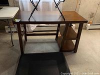 Full view of the wood office table showing the tabletop and side shelving.
