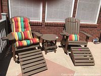 Full set of two rocking chairs with cushions, two ottomans and round table on patio