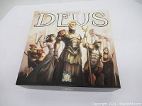 Closed box of Deus board game showing cover artwork with classical figures.
