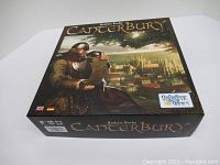 Photo of Canterbury board game box showing knight holding a scroll and city in background, game title and publisher visible.