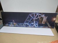 Full view of the Johnson Street Bridge print mounted on board laid on a table.