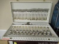 Full view of Axendale flatware set in original lined case, showing forks on top section and spoons on bottom section.