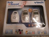 Front view of the boxed VTech Safe & Sound DM223 Digital Audio Monitor, showing baby unit and two parent units through window.