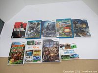 Collection of Nintendo Wii and Wii U game cases arranged on white background, showing front cover artwork for ten games.