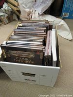 Cardboard box filled with hardcover RPG manuals showing front row of Dungeons & Dragons books
