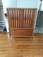 Full front view of armoire showing tambour doors and drawer base