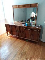 Wide shot of dresser with mirror showing overall shape, finish and top surface