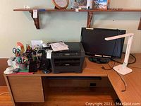 Desk setup with Brother HL-2280DW printer, Samsung 2433BW monitor, white LED desk lamp, and assorted office supplies on wooden desk.