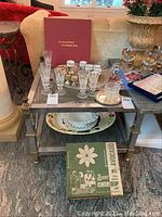 Overall lot shown on two-tier metal side table, items arranged for display.