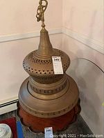 Full view of the antique brass Turkish brazier showing pierced decoration and shape