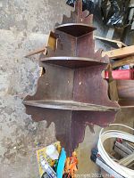 Top view showing two triangular shelves joined at a right angle with decorative shaped side panels and aged brown finish.