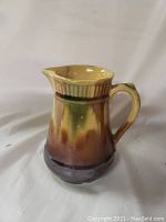 Small multi-glazed pitcher with handle and spout