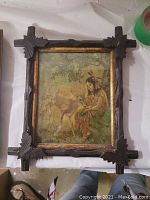Painting of Native American girl and deer in decorative dark wood frame, 10x12 inches