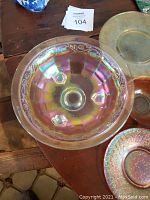 Top-down view of large iridescent carnival glass bowl showing inner pattern and colors