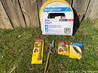 Full view of the air tools lot showing the air hose box and four packaged accessories on grass.