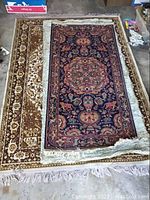 Three layered area rugs: patterned runner atop two larger carpets