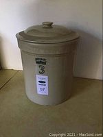 Front view of the beige ceramic crock with black markings showing '3' and branding.