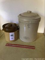 Full view of both crocks with lids and a measuring ruler showing scale