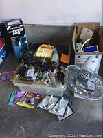 Overall view of tools, cords, power post box, trouble light, toolbox and other items.