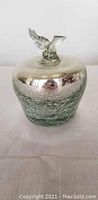 Photo of a silver and textured glass apple figurine showing front view with stem and leaves