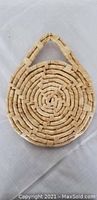 Top view of the circular woven natural fiber frame showing texture and handle