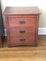 Front view of one stand showing pull-out writing surface and two drawers