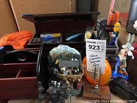 Photo showing group of office organizers, including pencil caddy, decorative bookend, Bugs Bunny figure, and clocks