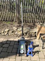 Full view of the Pittsburgh Automotive floor jack with two blue Duralast jack stands on paved ground outdoors.