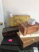 All six jewelry boxes stacked showing their variety in size, design, and materials.