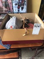 Box containing 5 vintage hats in various styles and colors, some showing floral accents and netting.
