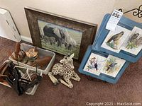 Overview of framed elephant wall art, plush giraffe, and bird placemats