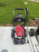 Top front view of the Black Max pressure washer showing the Honda GCV 160 engine and hose coiled around the frame.
