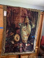 Full view of vintage Elizabeth Brandon tapestry showing birds, large urn, dried plants, and brick background with decorative border.