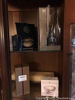 Shelf with various boxed diffusers and votive candle holder