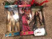 Three Barbie dolls from the Dolls of the World Princess Collection in original sealed packaging, arranged side by side on carpet.