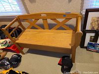 Front view of the wood bench showing seat and backrest with crisscross design