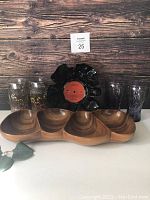 Lot contents showing two sets of vintage Coke glasses, three fountain glasses, a divided wood serving bowl, and a vinyl record bowl.