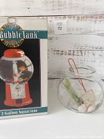 Wide shot showing both the boxed BubbleTank aquarium and the separate glass fishbowl with accessories inside