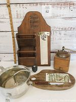 Full set showing wooden message board with grocery list, food mill, spice grinder, and cheeseboard with tile and grater on rustic background.