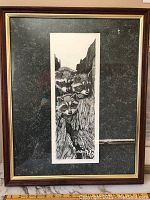 Raccoon print framed in dark metal frame with gold inner trim, showing three raccoons. Approximate overall size 17.5x21.5 inches.