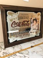 Full view of vintage Coca Cola mirror framed in wood, showing overall design and size representation with measuring tape.