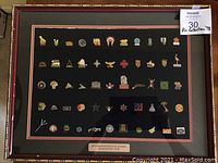 Full view of framed pin collection from XI Commonwealth Games 1978 on a black background with multiple pins arranged in rows.