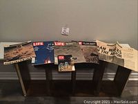 Wide view of all items displayed on small table showing the variety of magazines and newspapers commemorating the moon landing in 1969.